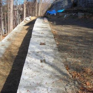 Walls made of concrete blocks in yard of bare dirt.